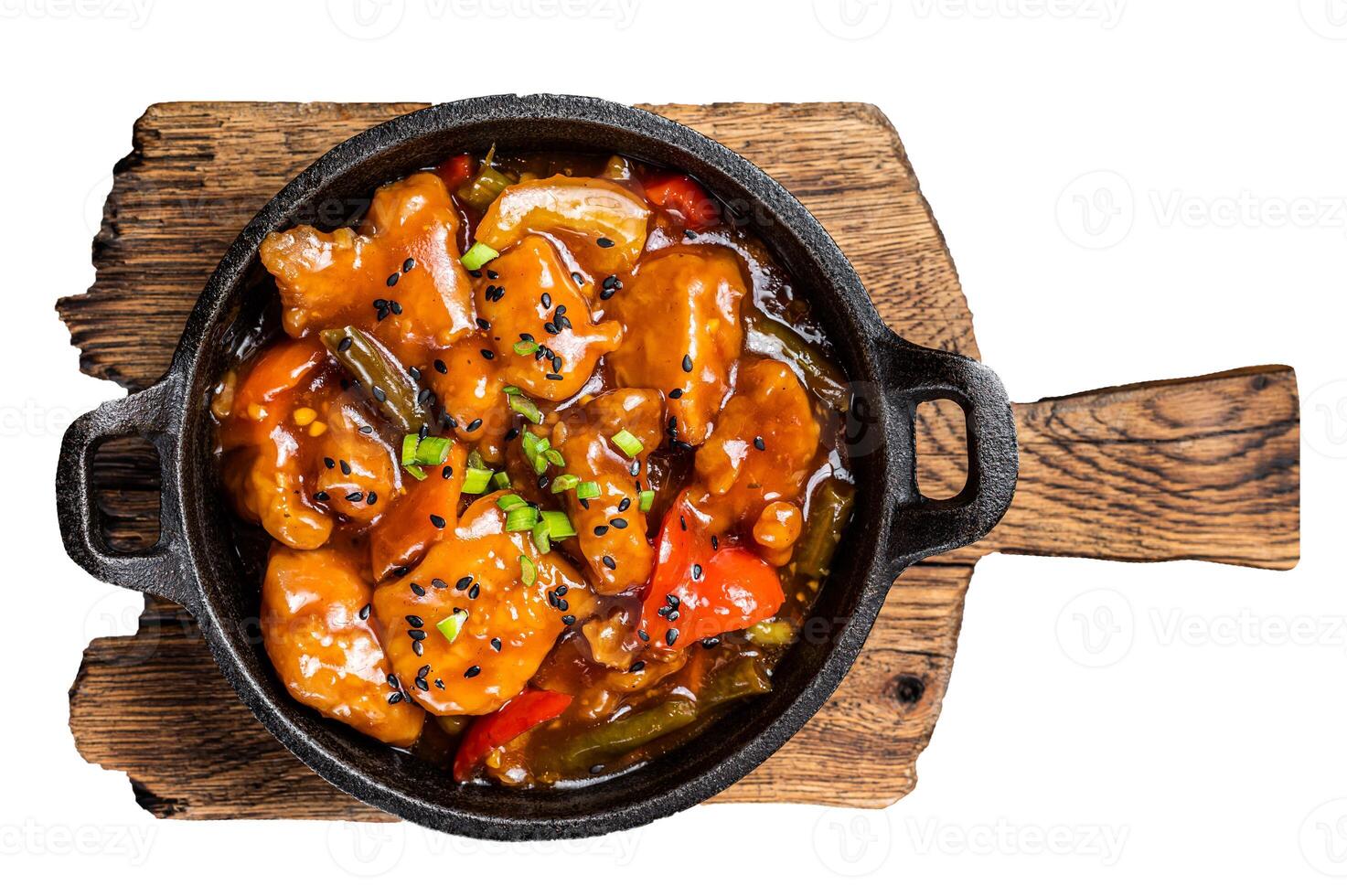 Chinese Sweet and sour chicken with colorful bell pepper in a skillet. Isolated, white background. photo