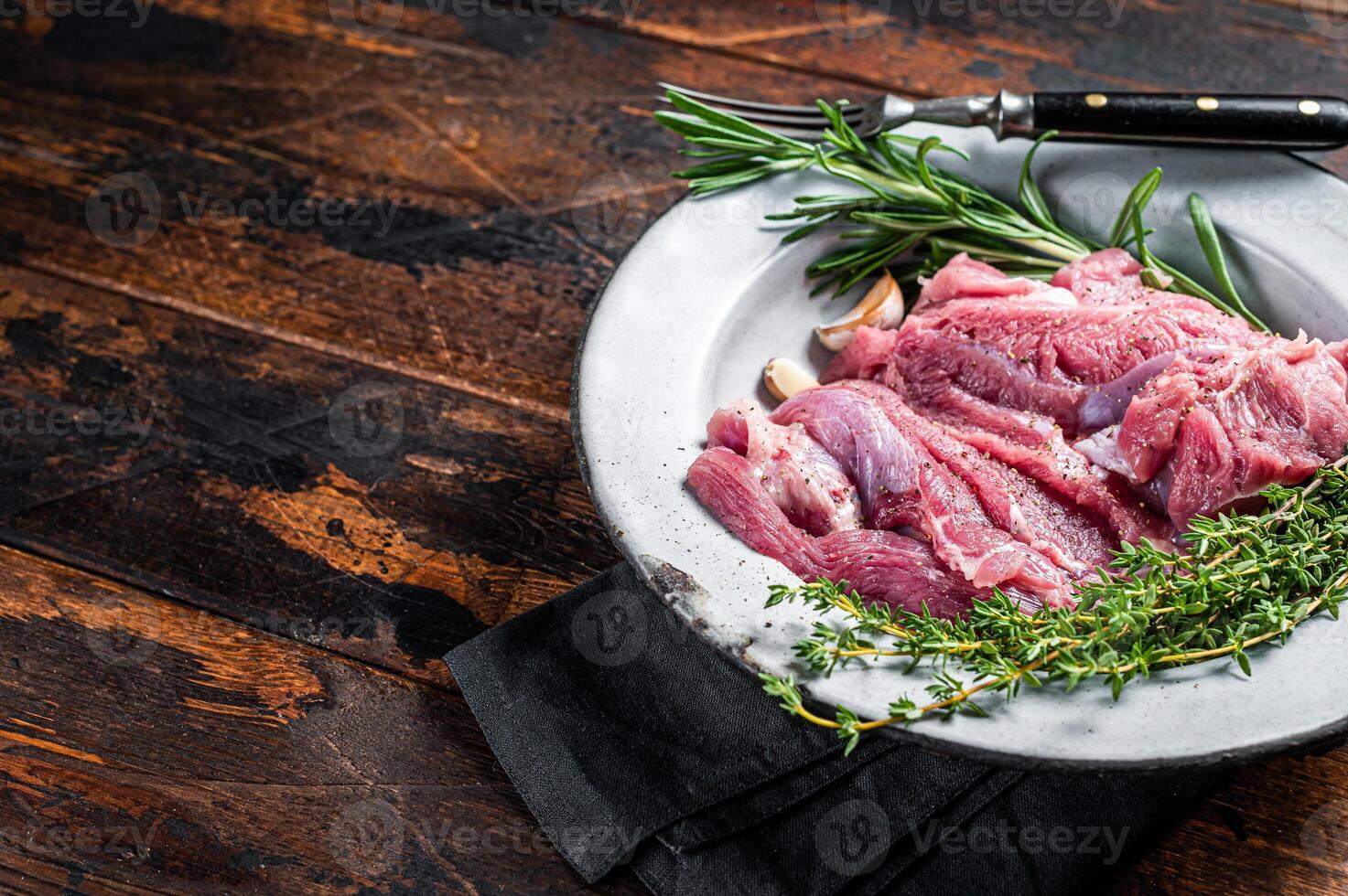 Pieces of raw turkey thigh, Poultry fresh meat. Wooden background. Top view. Space for text photo