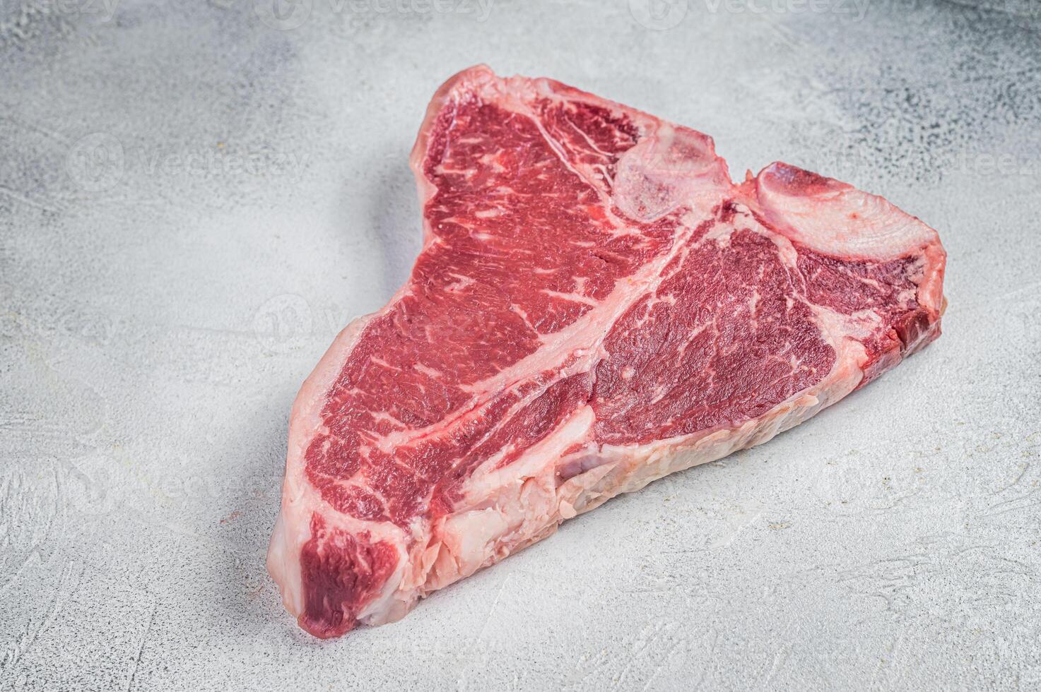 Porterhouse T-bone raw beef meat Steak. White background. Top view photo