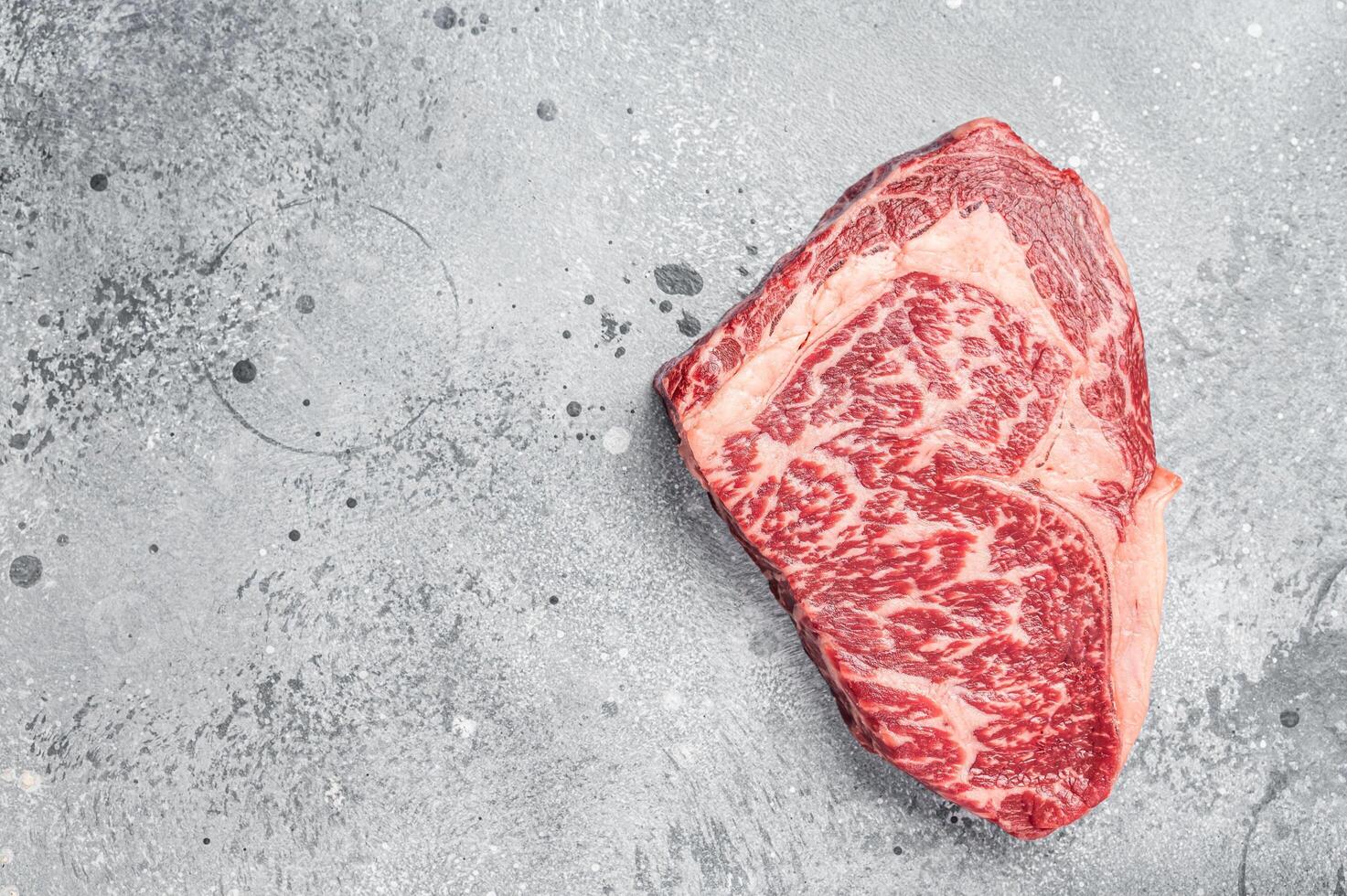 Japanese wagyu rib eye beef meat steak. Gray background. Top view. Copy space photo