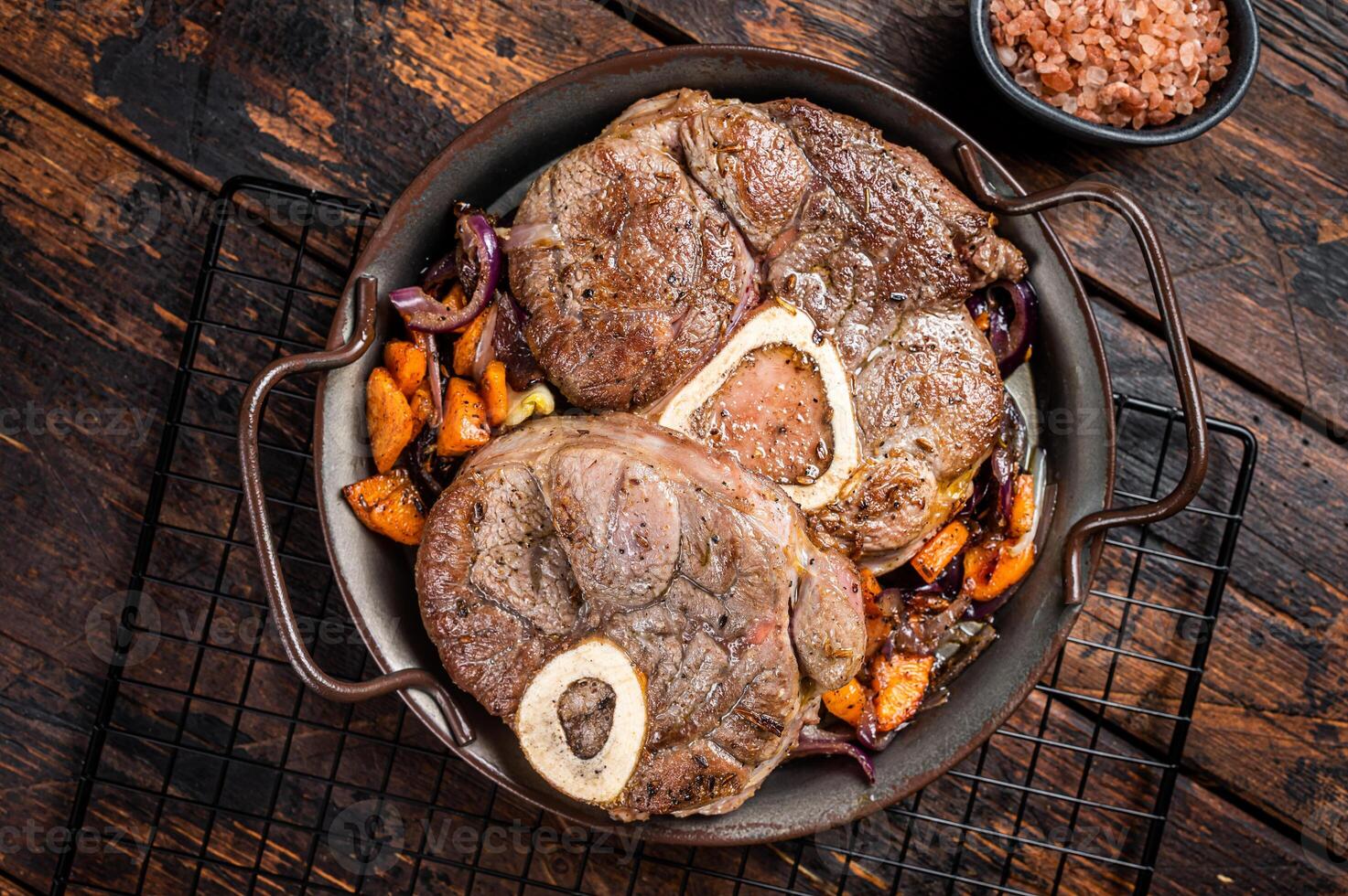 Veal shank stew Osso Buco, italian ossobuco meat steak. Wooden background. Top view photo