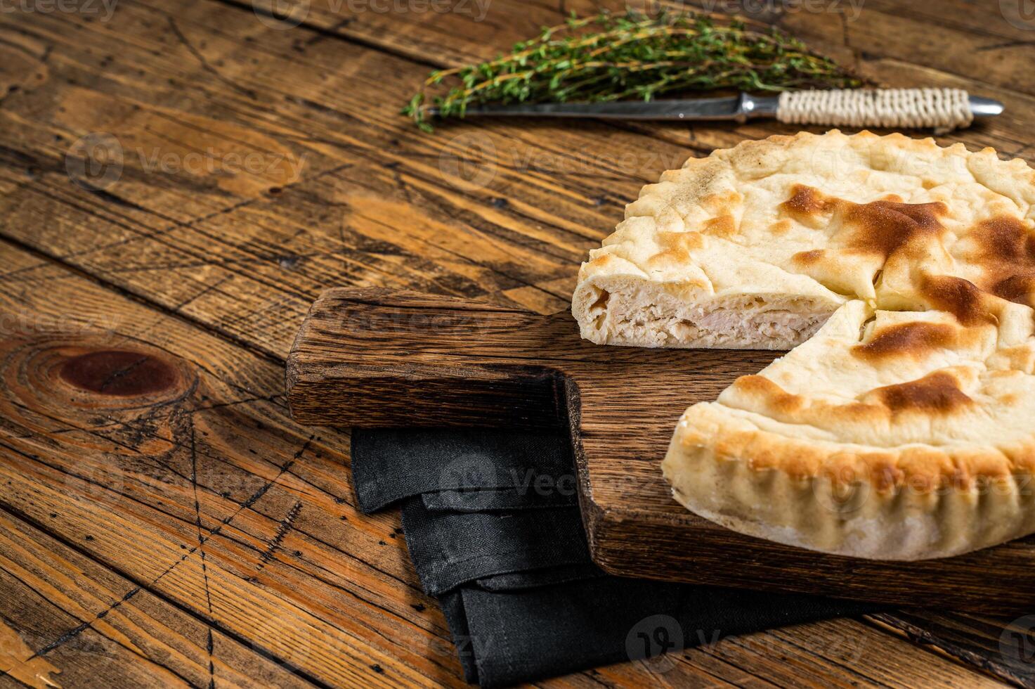 Kubdari Bread, Tasty Flat Bread Stuffed with Spiced meat. Wooden background. Top view. Copy space photo