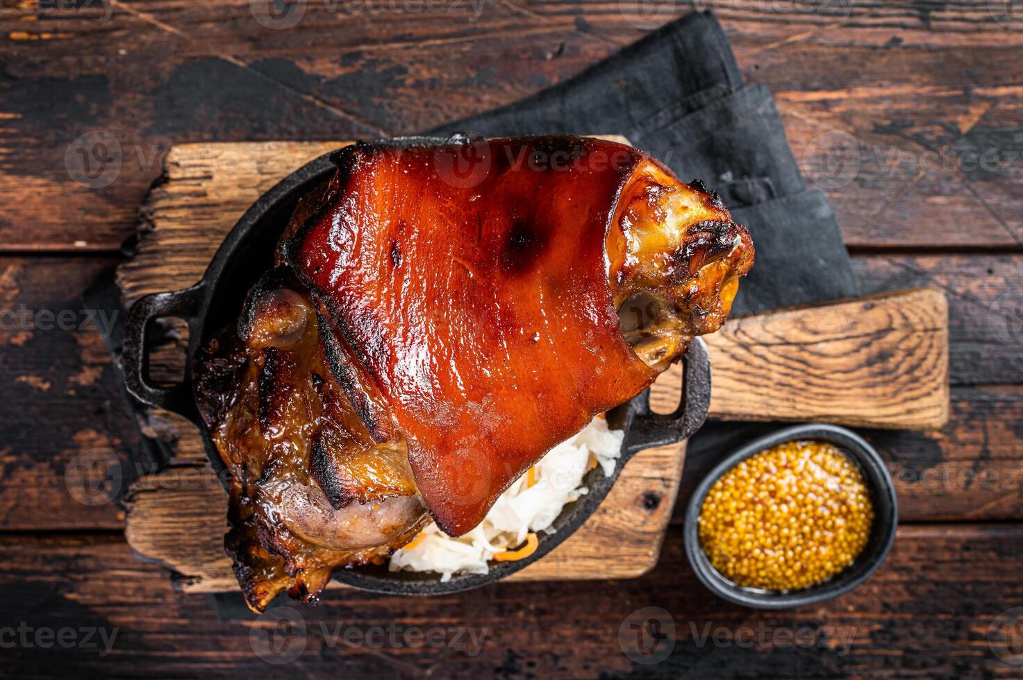 Bavarian Schweinshaxe Roast pork Hock Ham, knuckle with Sauerkraut. Wooden background. Top view photo