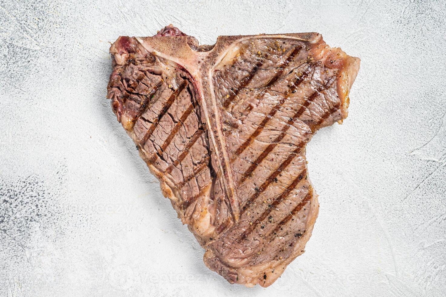 Grilled T-bone or Porterhouse beef meat Steak. White background. Top view. Copy space photo