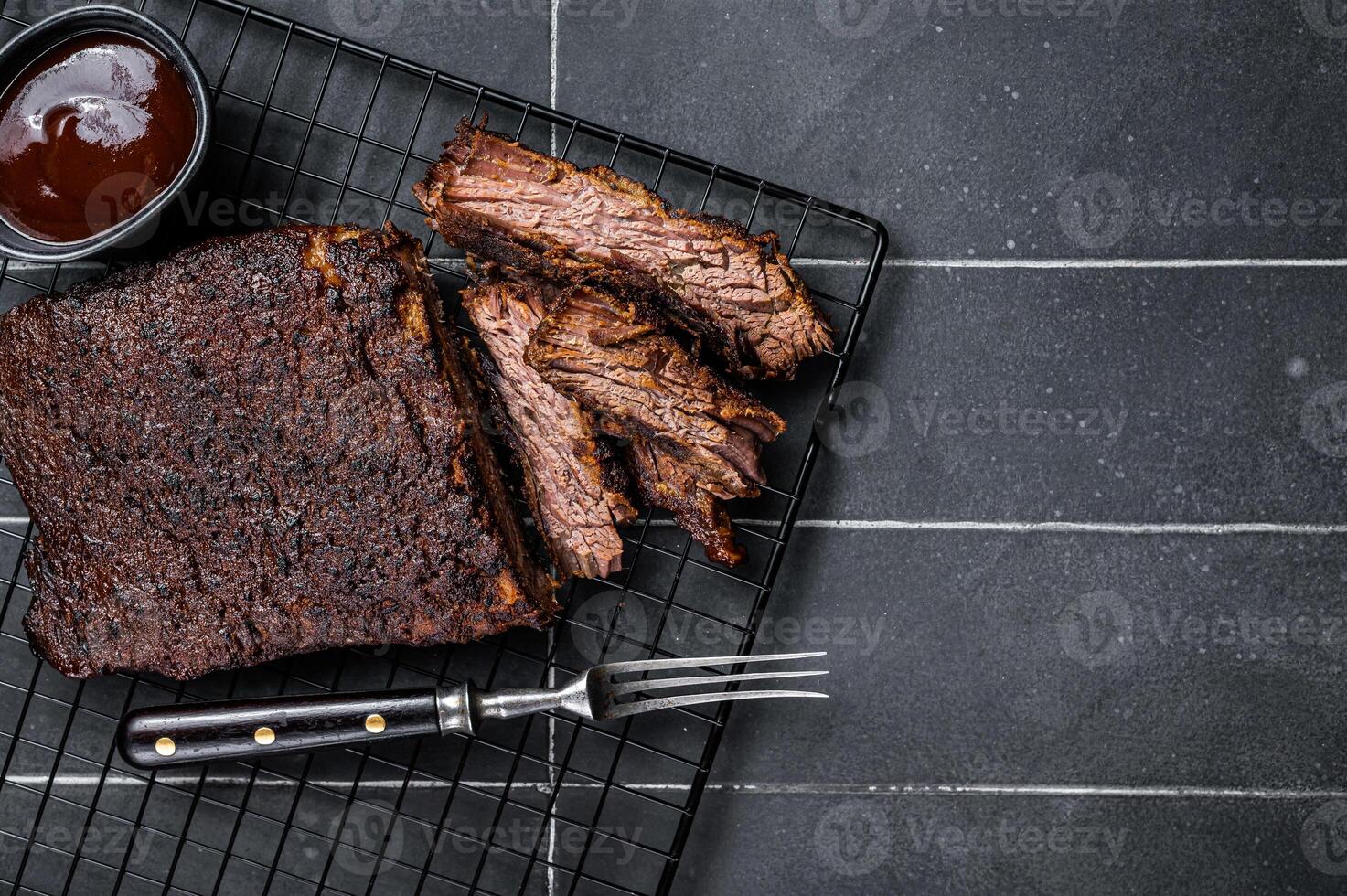 Chopped Beef Brisket barbecue, Traditional meat rubbed with spices and smoked in a Texas smoker. Black background. Top view. Copy space photo
