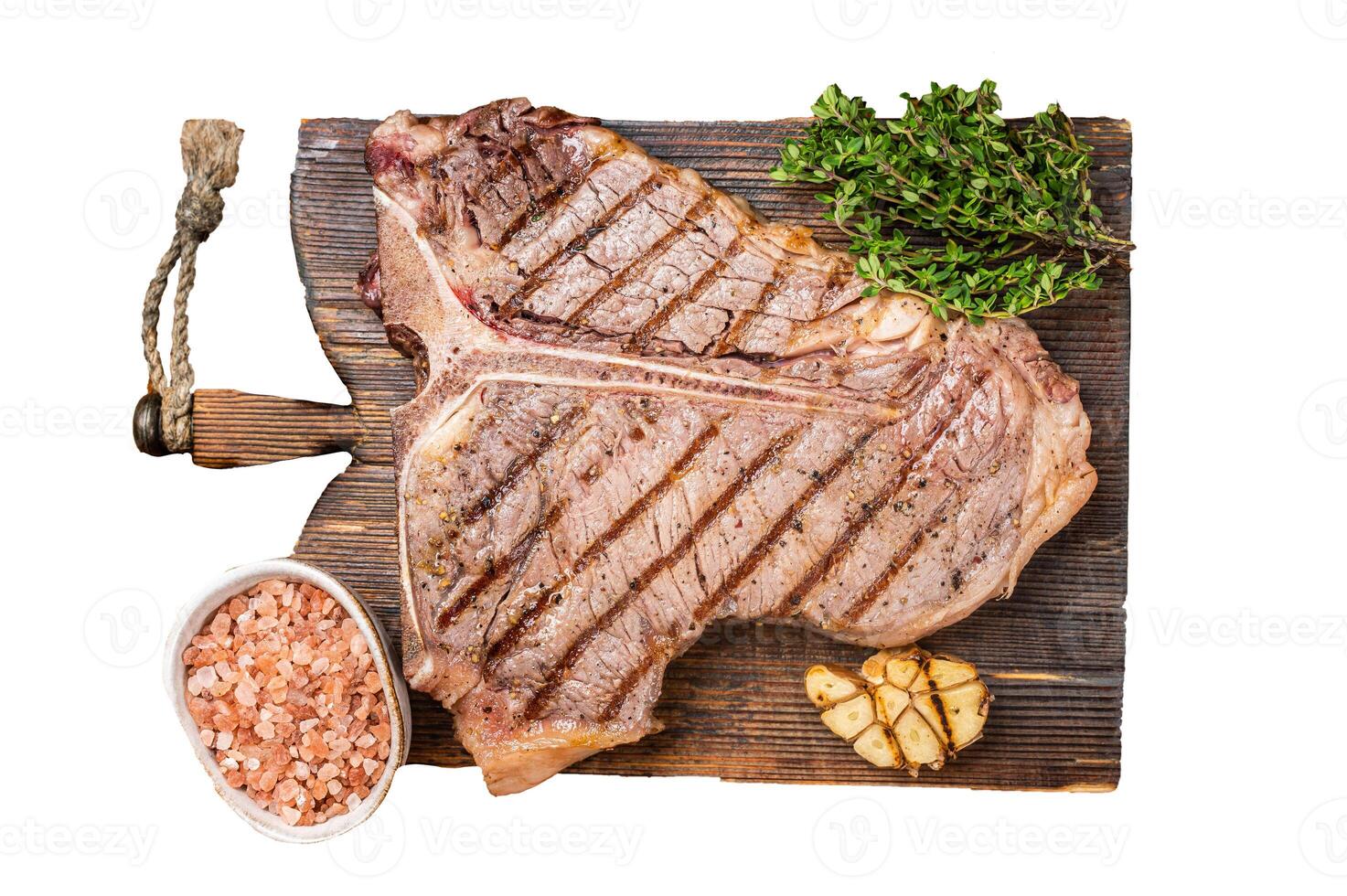 BBQ Roast T bone or Porterhouse beef meat Steak on a wooden board with spices. Isolated, white background. photo