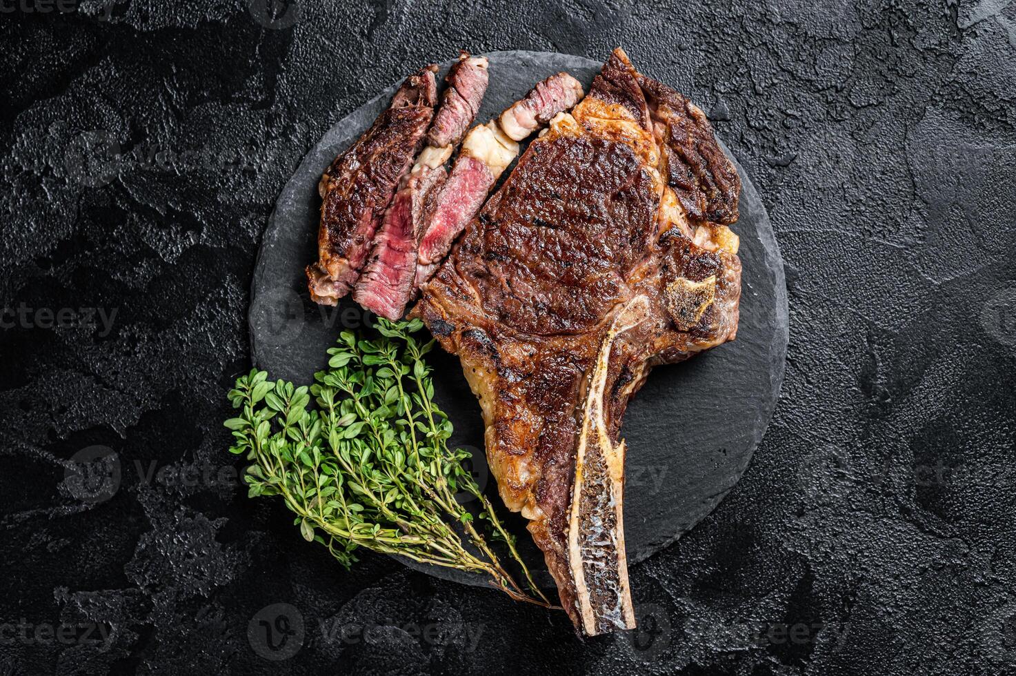 Roasted Tomahawk or cowboy with bone beef meat steak. Black background. Top view photo