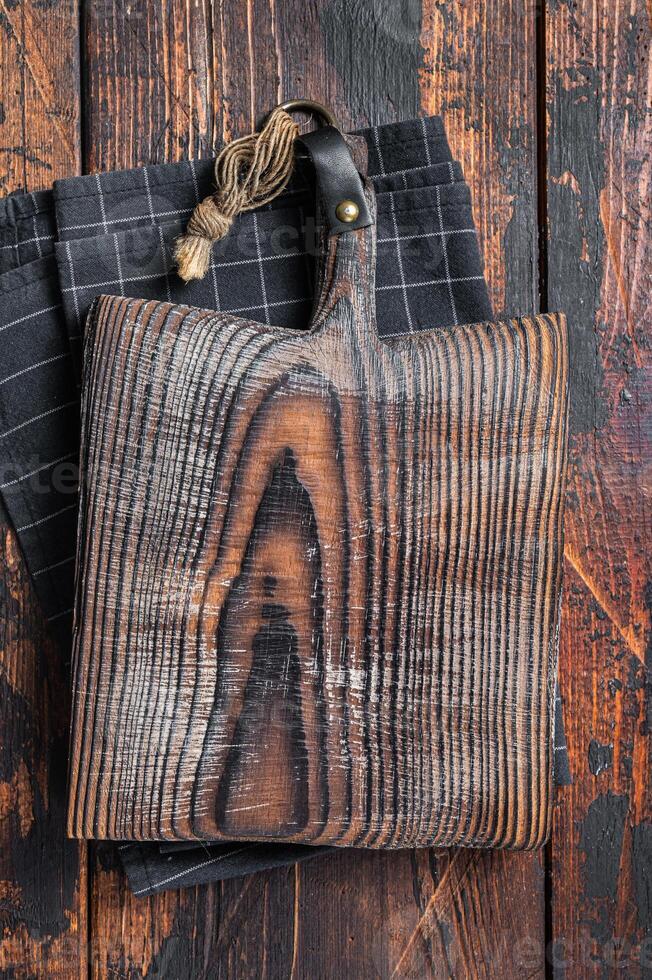 Directly Above view Of Cutting Board On dark Wooden Table. Wooden background. Top view. Copy space photo