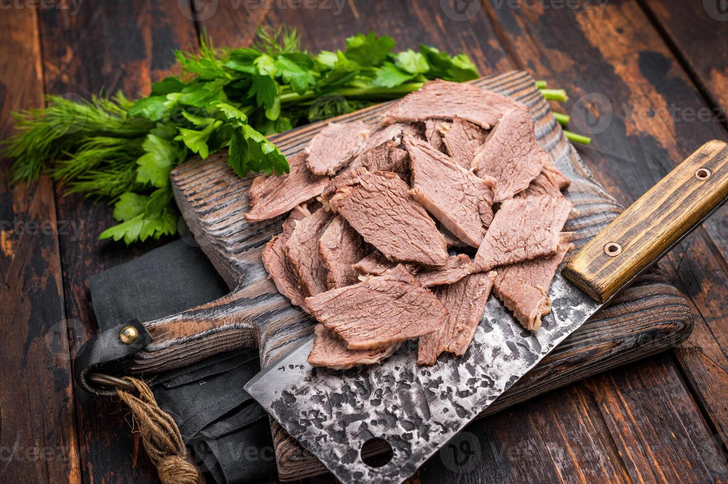 Corned sliced beef meat on wooden cutting board. wooden background. top view photo