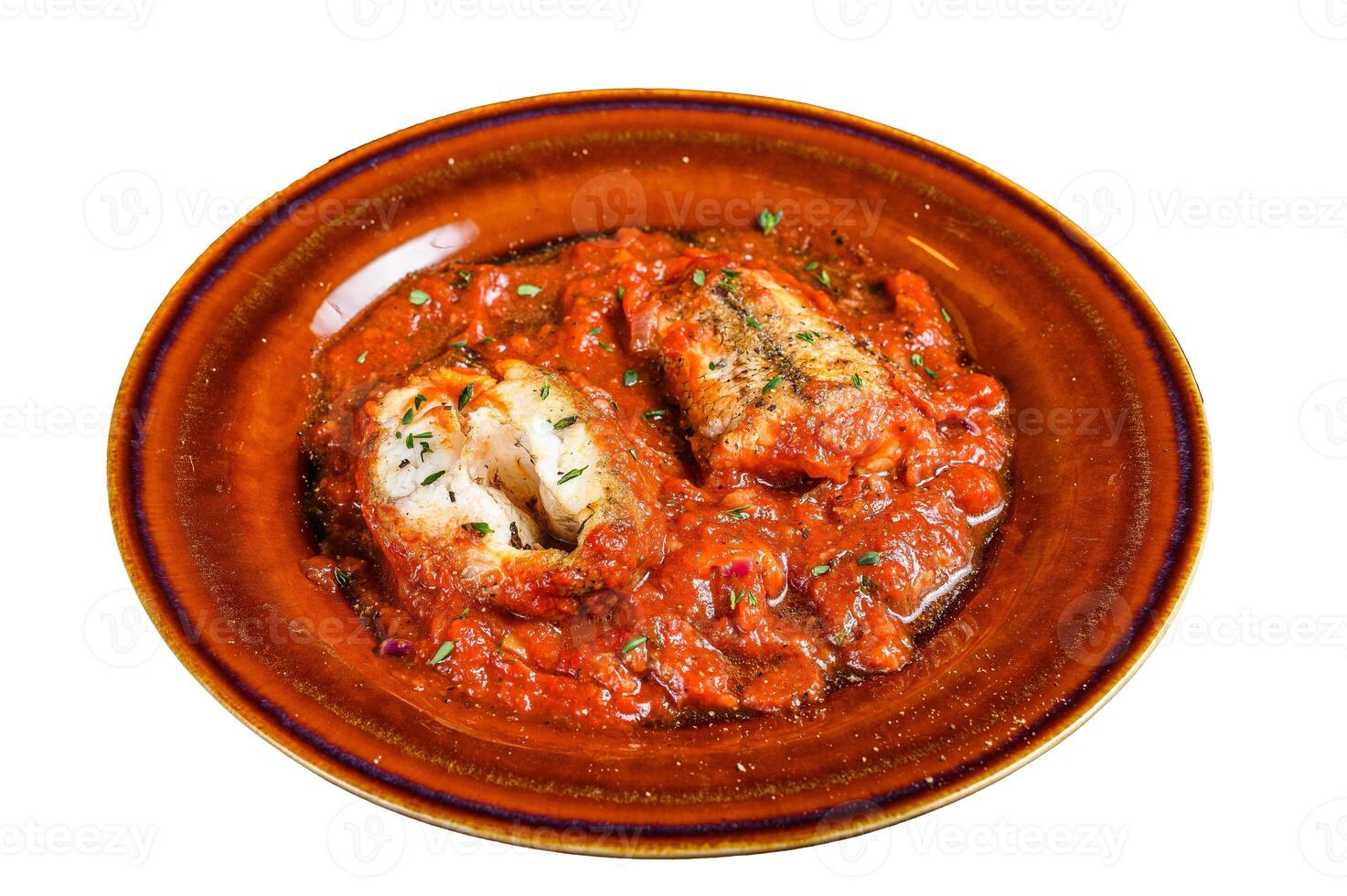Roast hake white fish fillet with tomato sauce in a plate. Isolated on white background. photo