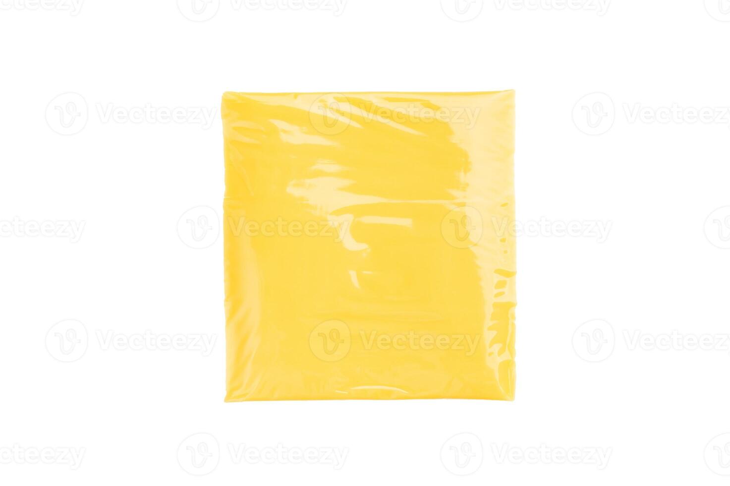 Square Slices of processed Cheddar cheese in individual plastic packaging isolated on white background photo