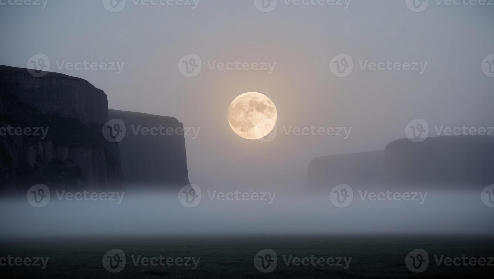 Silhouettes of Tall Cliffs with a Full Moon in a Foggy Landscape. photo
