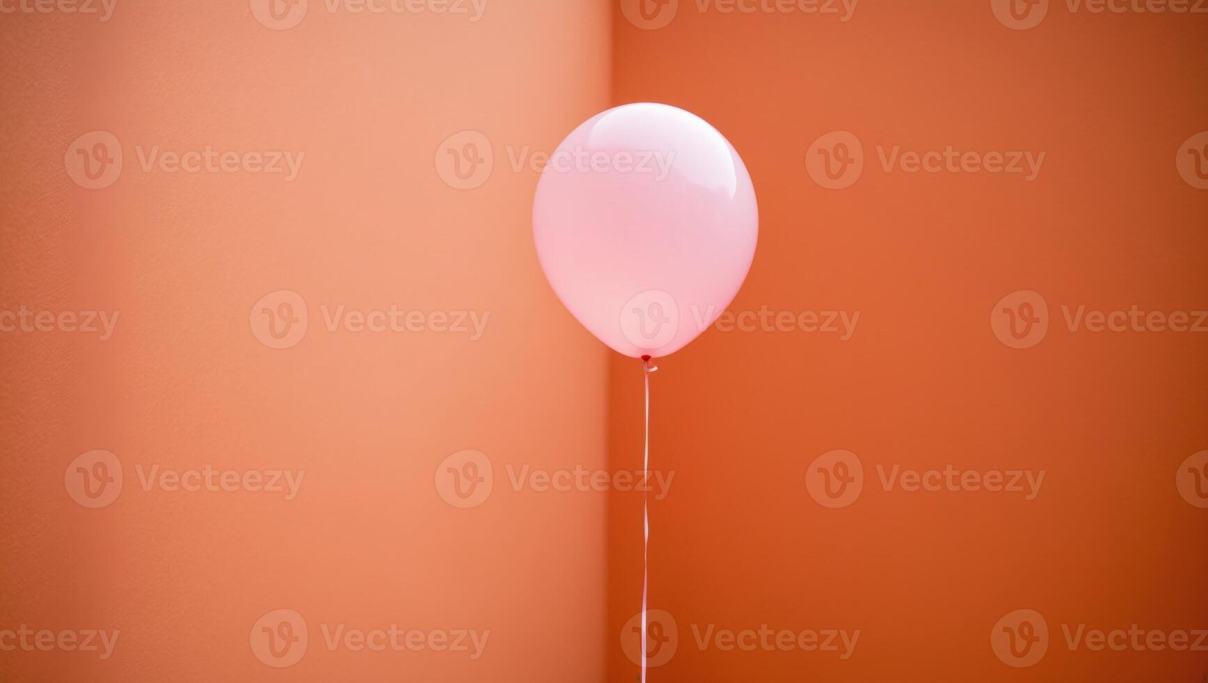 pink balloon flying on an orange background. photo