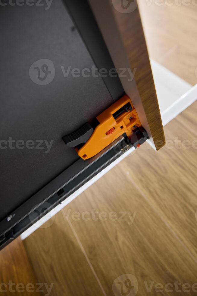 This modern drawer slide has a unique orange component that boosts functionality and aesthetics photo