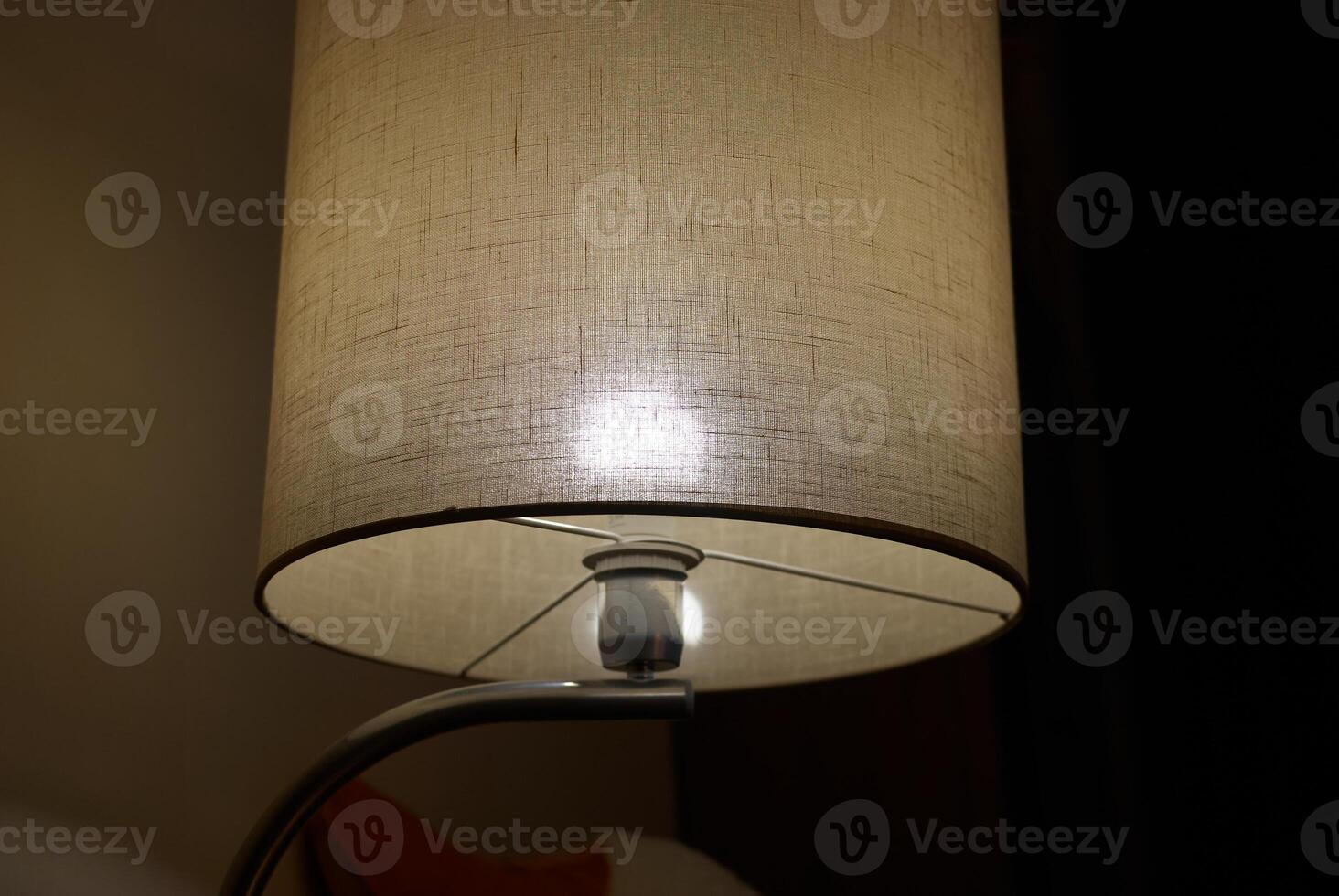 This elegant table lamp produces a soft glow, creating a cozy and inviting ambiance photo