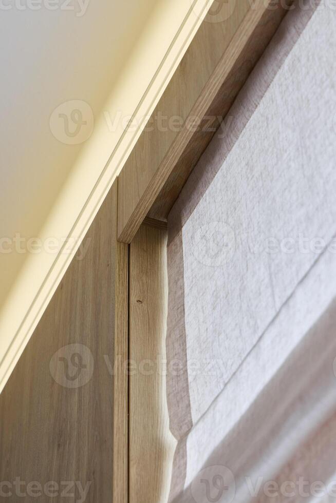 An Elegant Wooden Trim Featuring Soft Fabric Blinds for a Chic and Inviting Ambiance photo