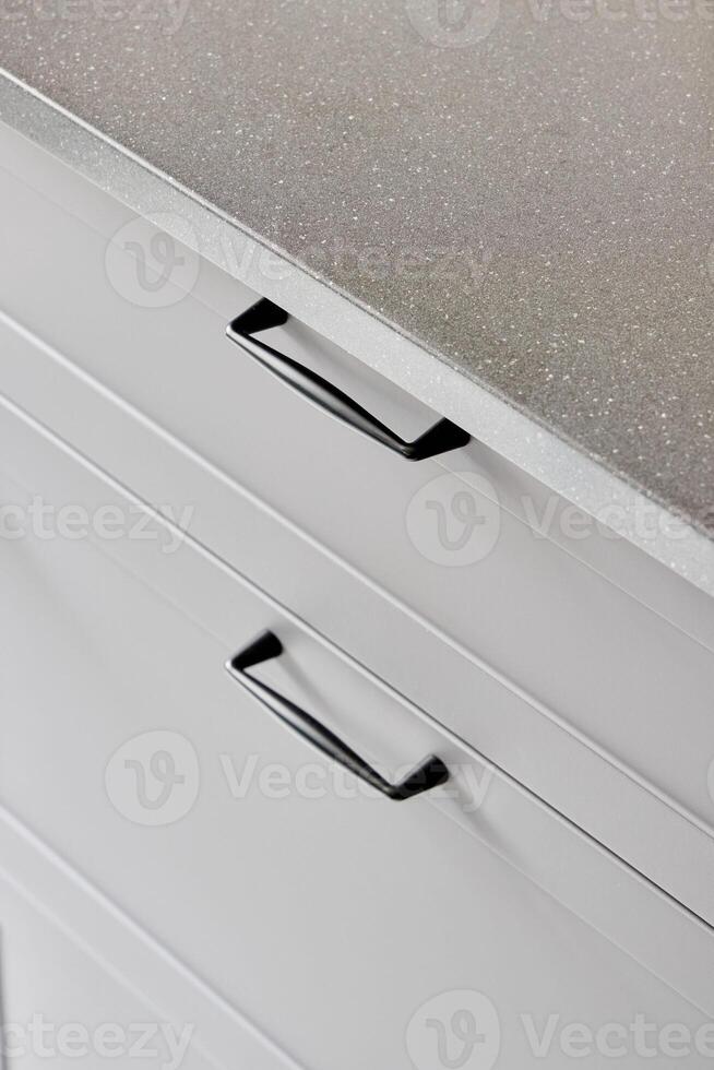 Modern Kitchen Drawer Handles on a Sleek Countertop Enhancing the Overall Aesthetic photo