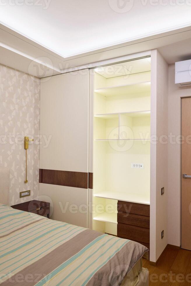 Modern bedroom interior with a builtin wardrobe and soft, inviting lighting for warmth photo