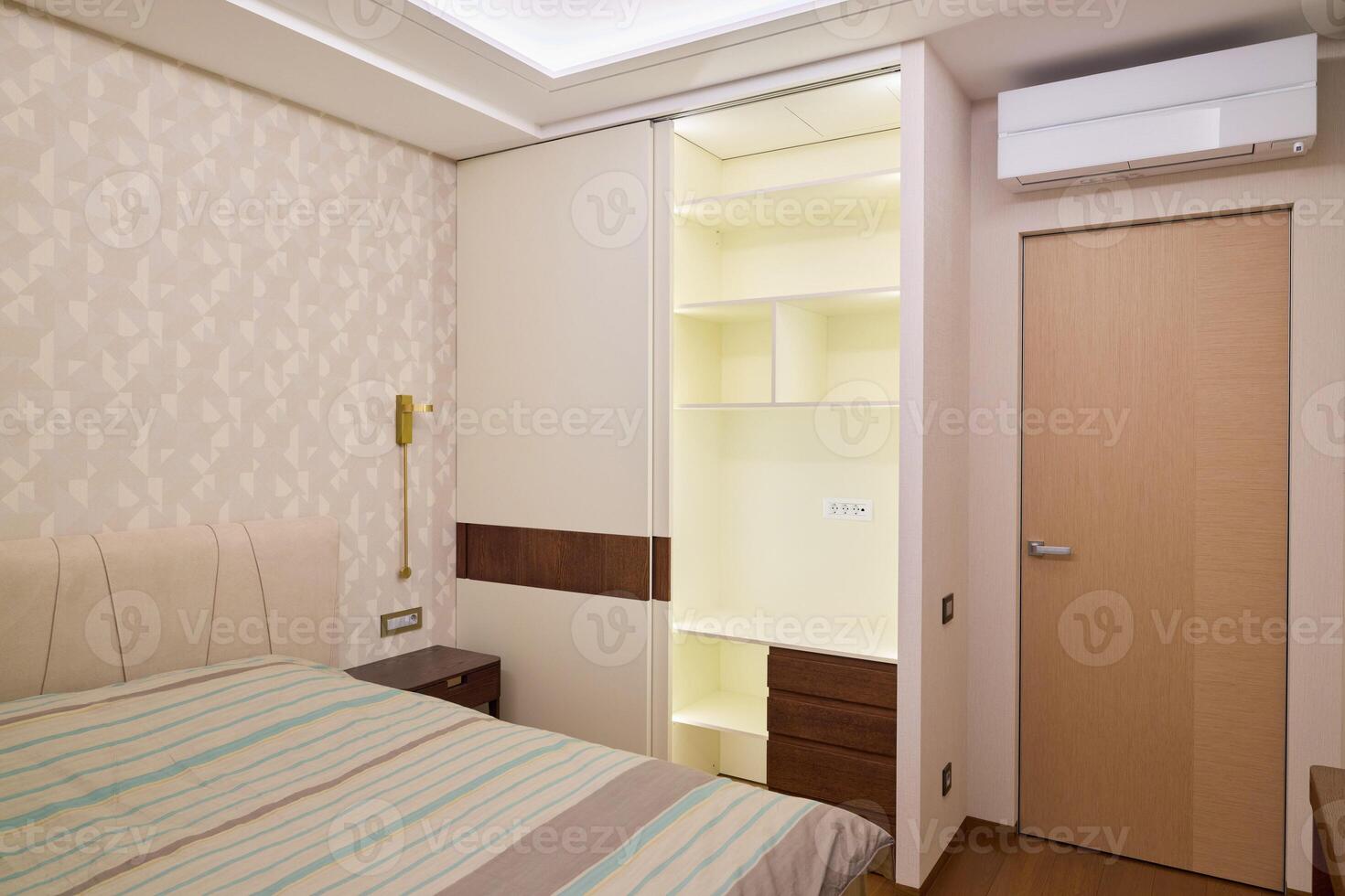 Stylishly Modern Bedroom Design Featuring Builtin Wardrobe and Efficient Air Conditioning photo