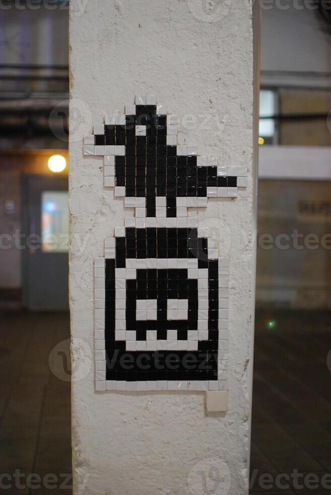 A Unique Pixel Art Mosaic Creating a Striking Contrast on an Urban Wall for All to See photo