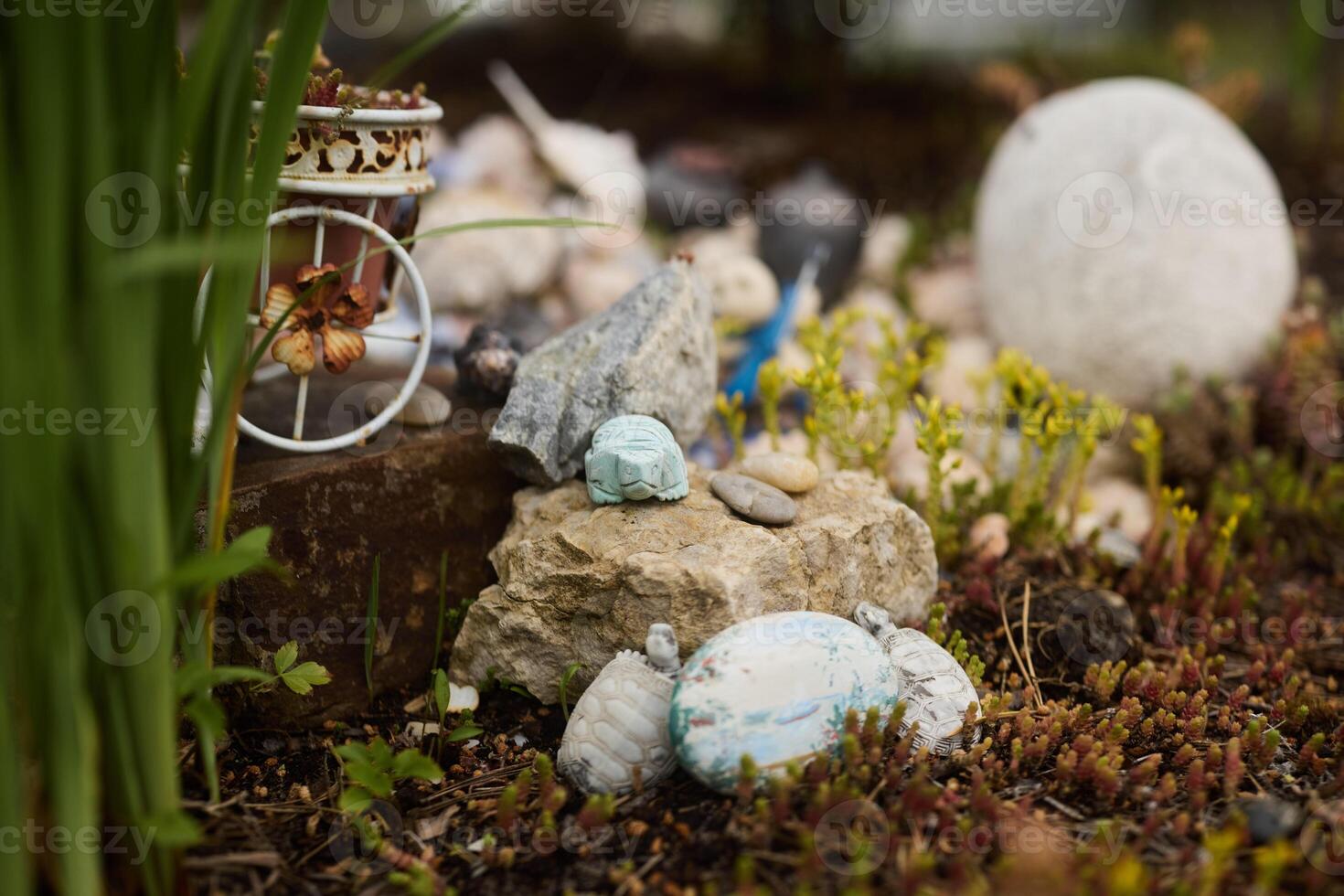 An Enchanting Miniature Garden Featuring Colorful Decorative Stones and Various Elements photo