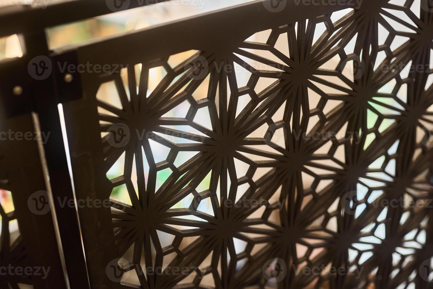 Decorative Metal Screen Featuring an Intricate Pattern That Beautifully Displays Light photo