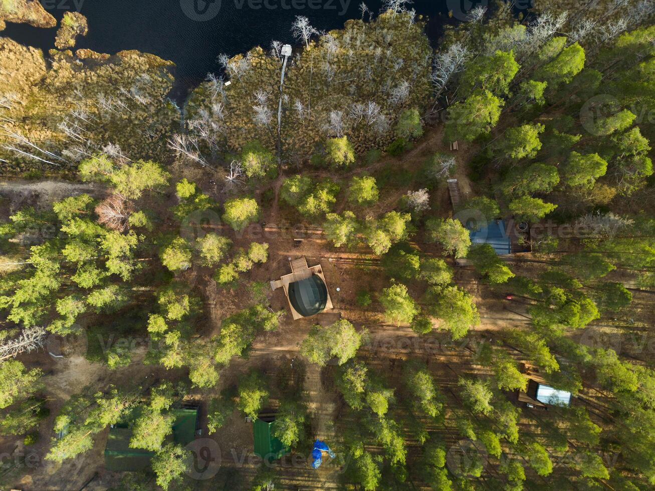An Aerial Perspective of a Serene and Peaceful Forest Retreat Surrounded by Tranquil Water photo