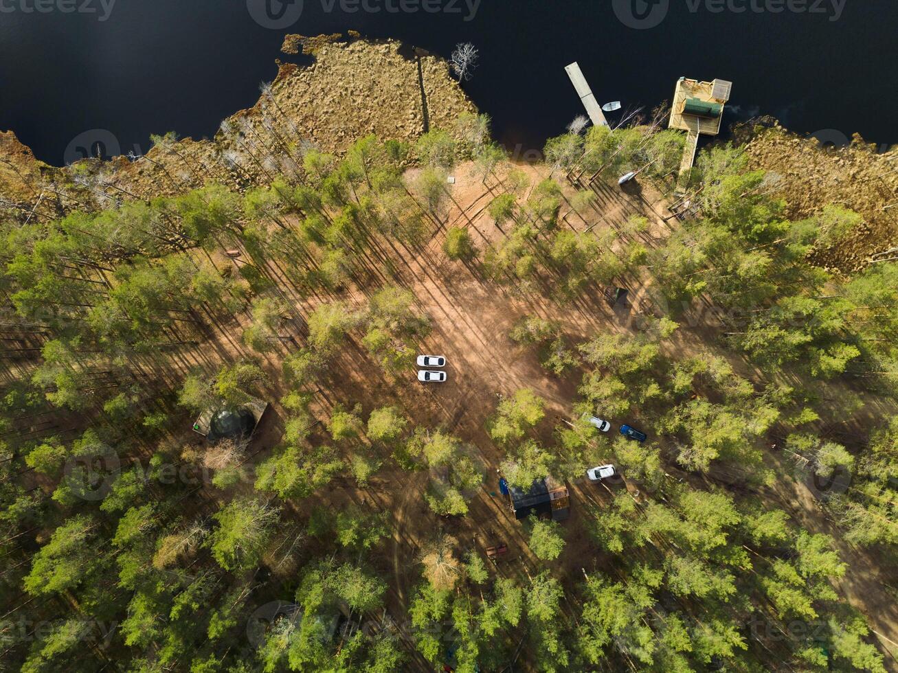 Breathtaking Scenic Aerial View of a Beautiful Forest and Tranquil Lake Camp Site photo