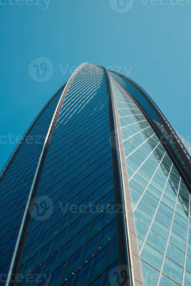 A Stunning Modern Skyscraper Perspective Set Against a Bright, Clear Blue Sky Background photo