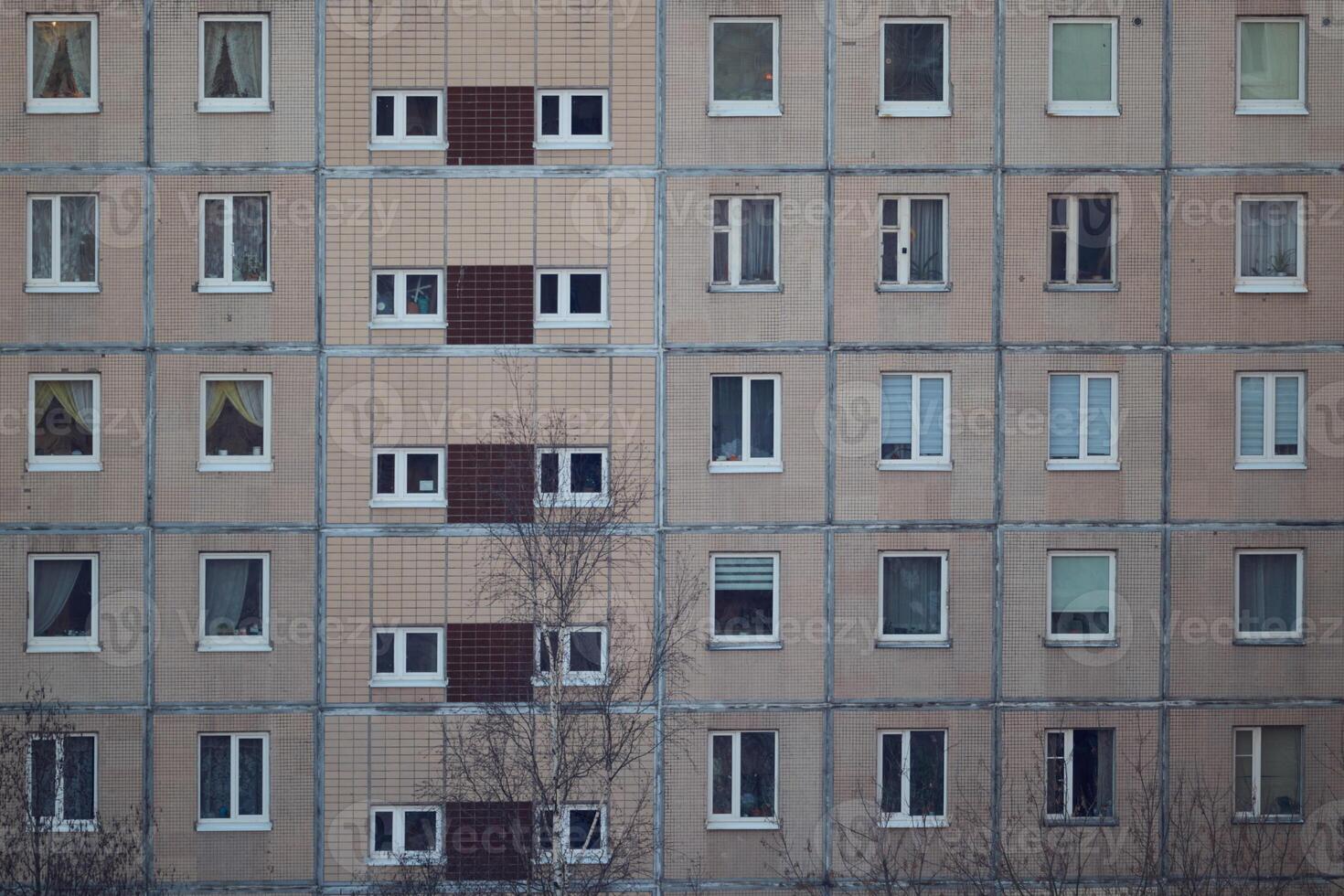 Urban Apartment Building Facade Featuring Numerous Windows and Contemporary Design Elements photo