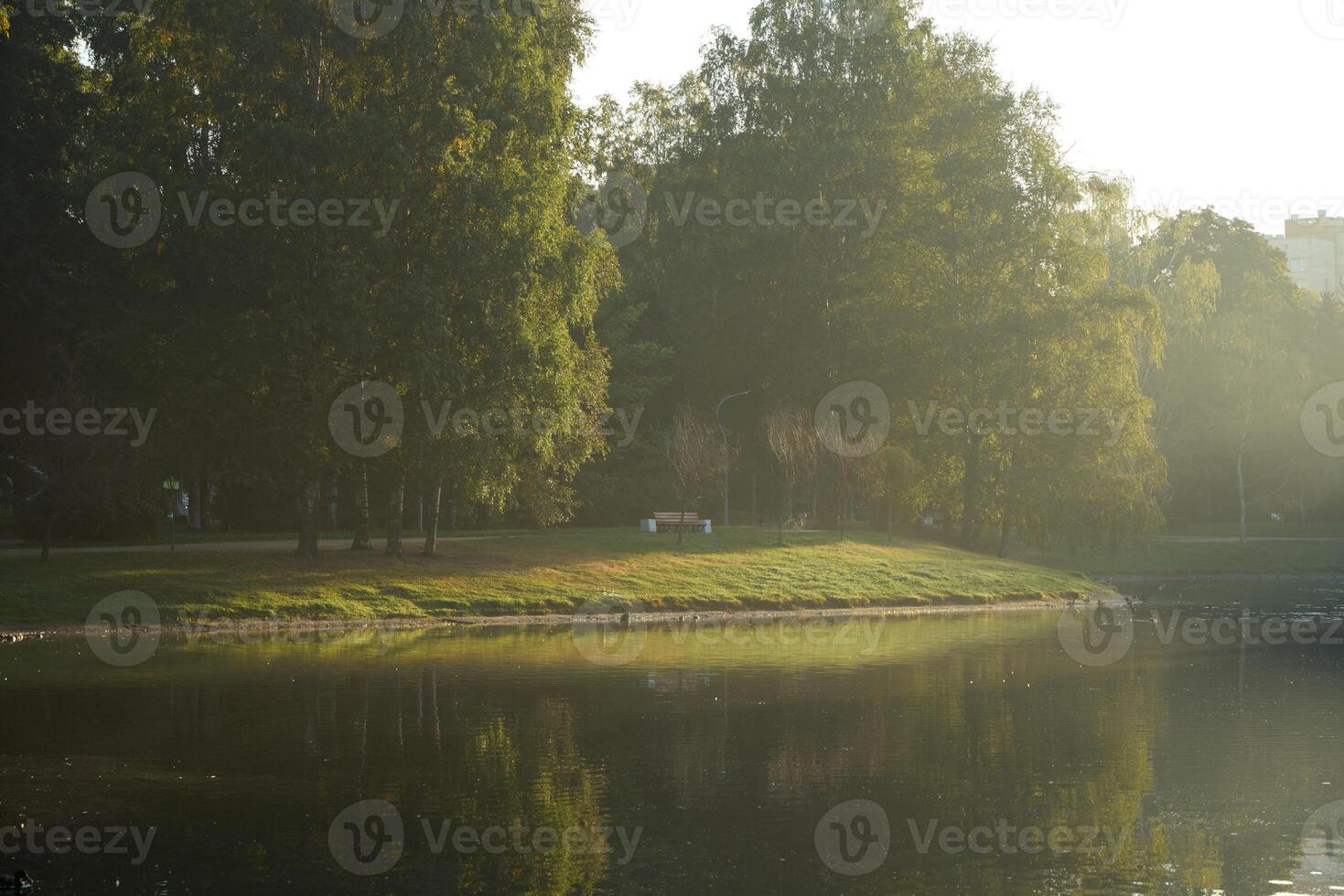 A Tranquil Morning at the Park with Beautiful Reflections on the Water Surface and Surroundings photo