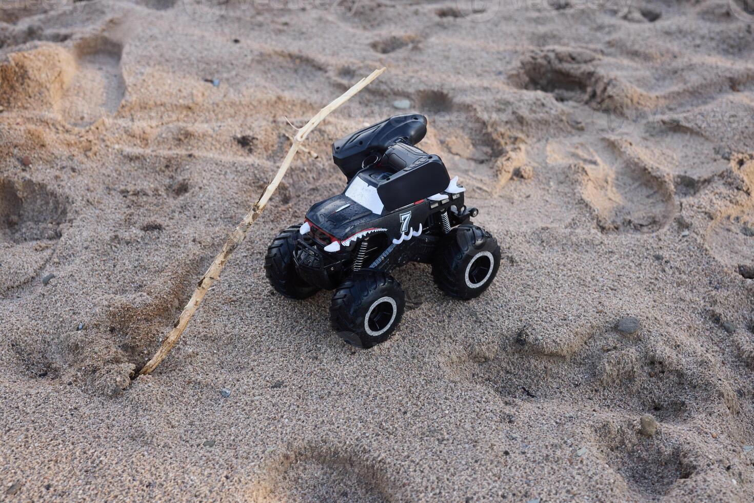 Experience the thrill of a RemoteControlled Monster Truck driving across a sandy beach photo