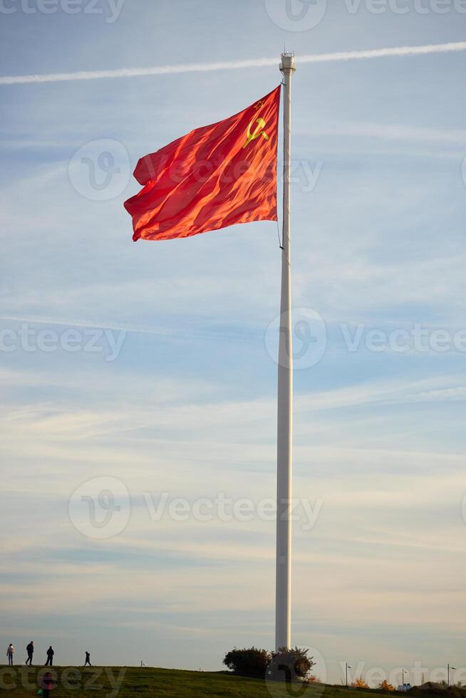 A grand and impressive Flag of China billows majestically against the expansive sky above photo