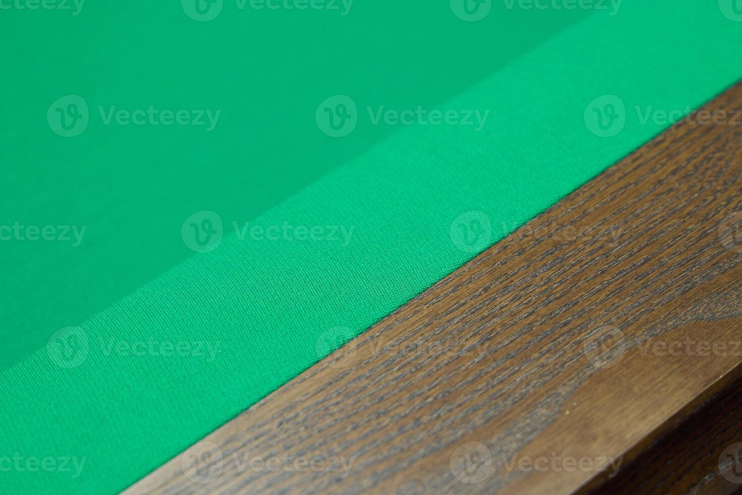A Green Felt Pool Table Surface Featuring a Beautiful Wooden Edge for Enhanced Aesthetics photo