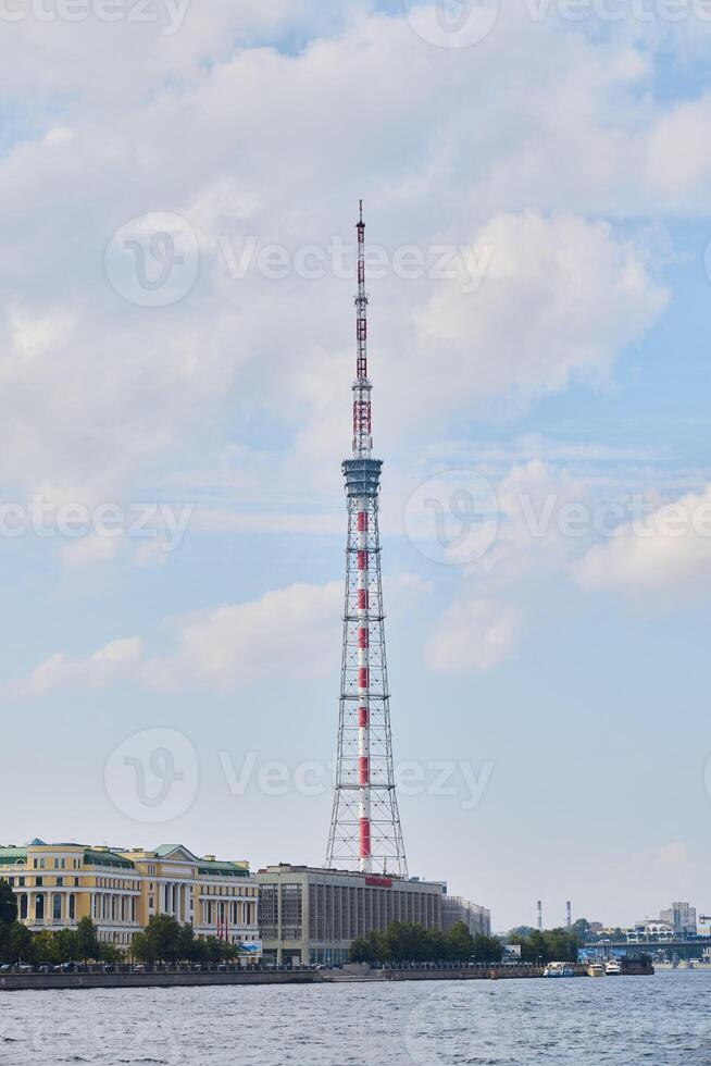 The Moscow Television Tower is beautifully surrounded by vibrant scenic water and clouds photo