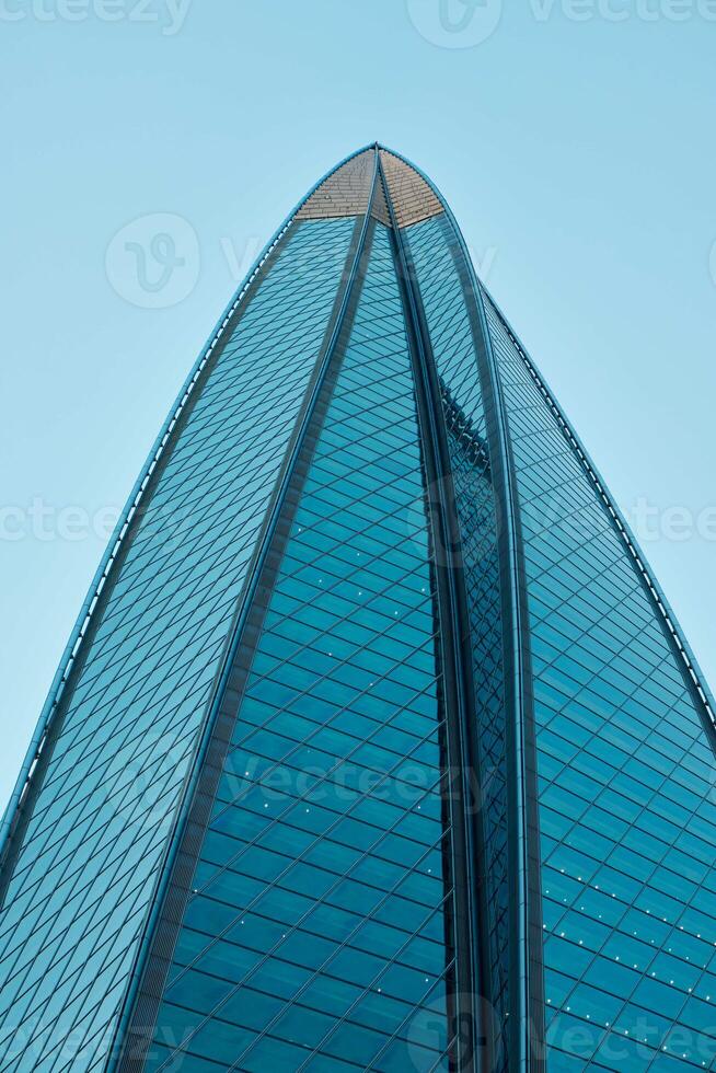 The Stunning and Beautiful View of a Modern Skyscraper Standing Tall Against a Clear Sky photo