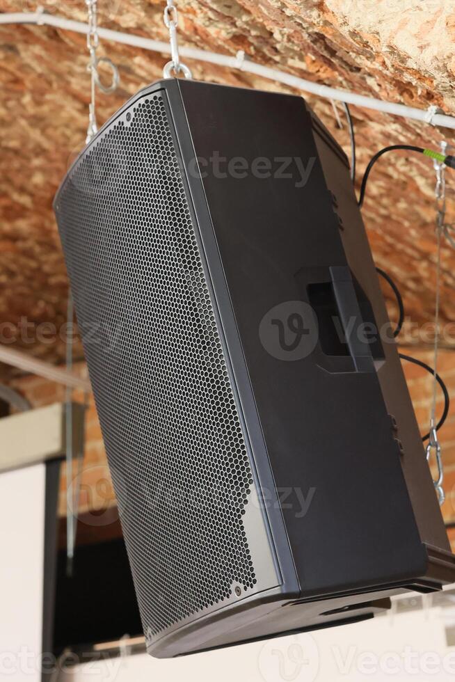 Hanging a Professional Sound Speaker in a Modern Venue for Enhanced Audio Experiences photo
