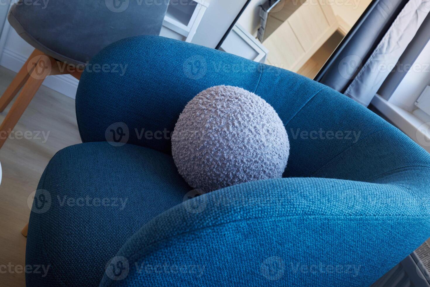 A Modern Armchair Featuring a Cozy Circular Cushion Set in a Delightfully Stylish Interior photo