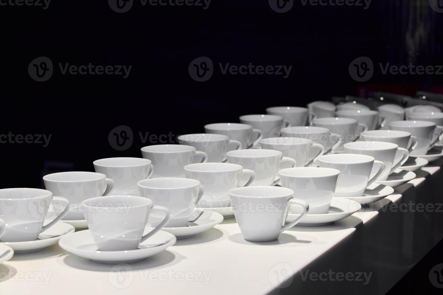An Array of Elegant White Coffee Cups Beautifully Arranged on Display for All to Enjoy photo