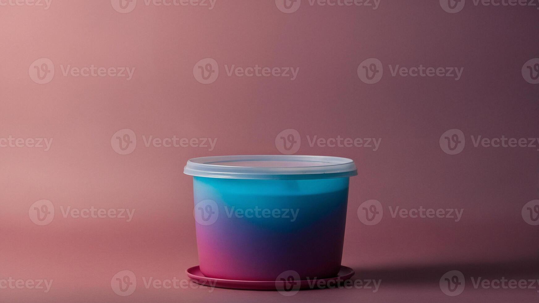 A plastic container with a lid on a pink background photo