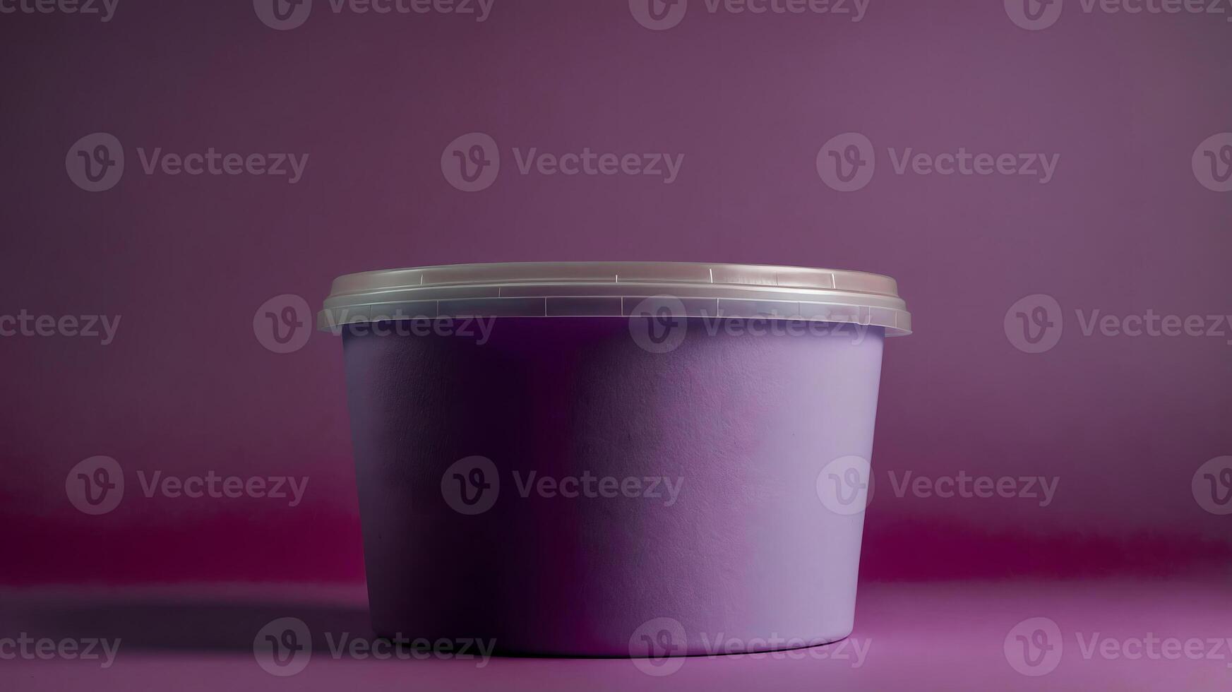 A purple plastic container with a lid on a purple background photo