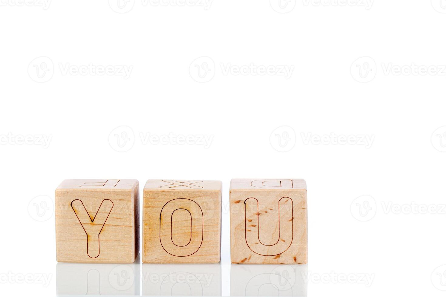 Wooden cubes with letters you on a white background photo