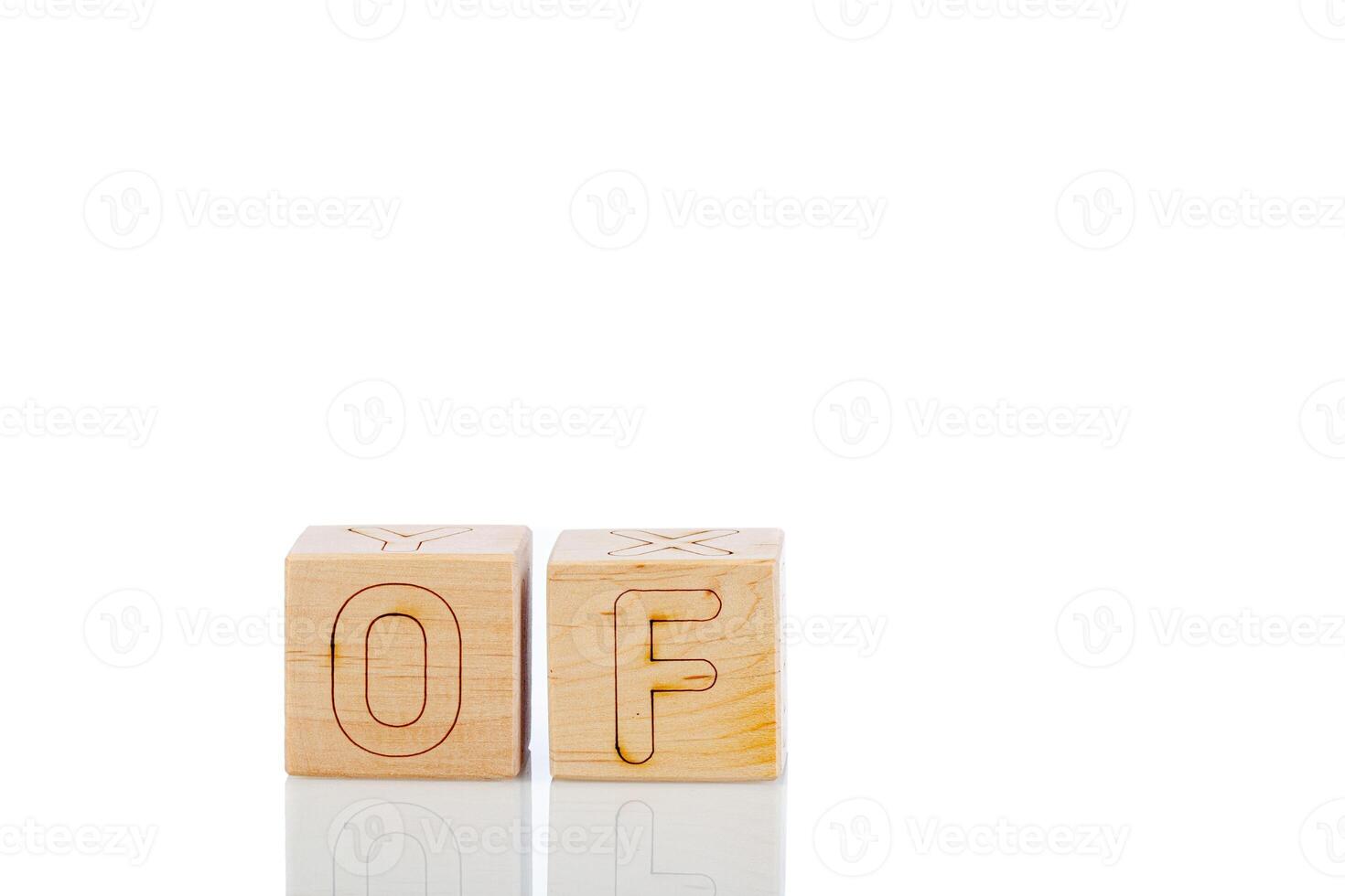 Wooden cubes with letters of on a white background photo