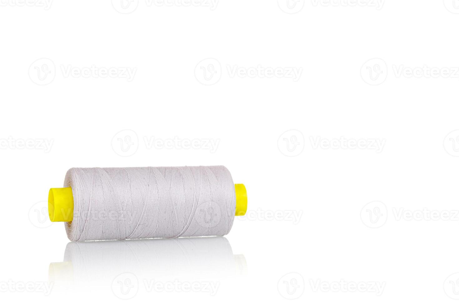skein of beige color thread macro on a white background photo