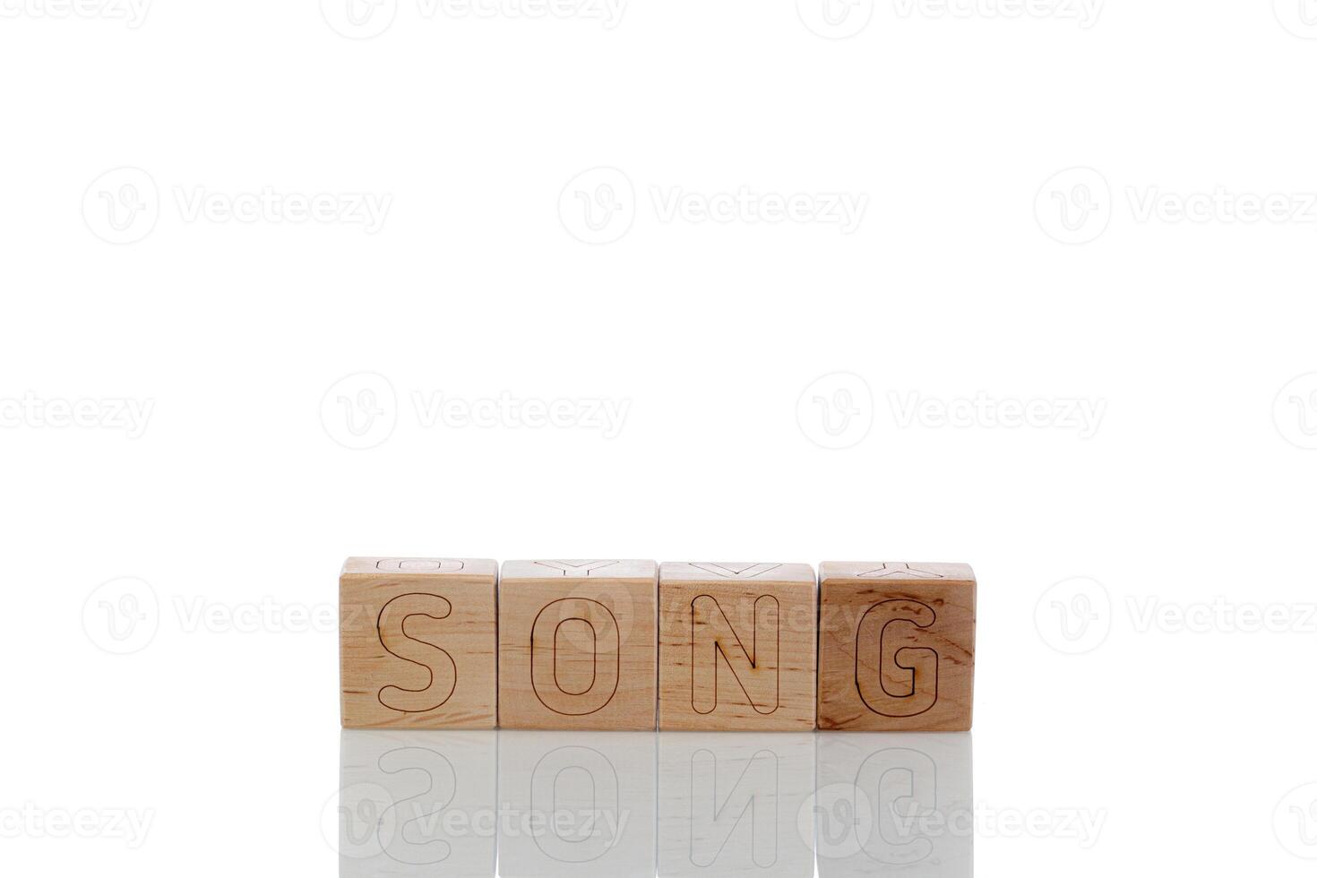 Wooden cubes with letters song on a white background photo