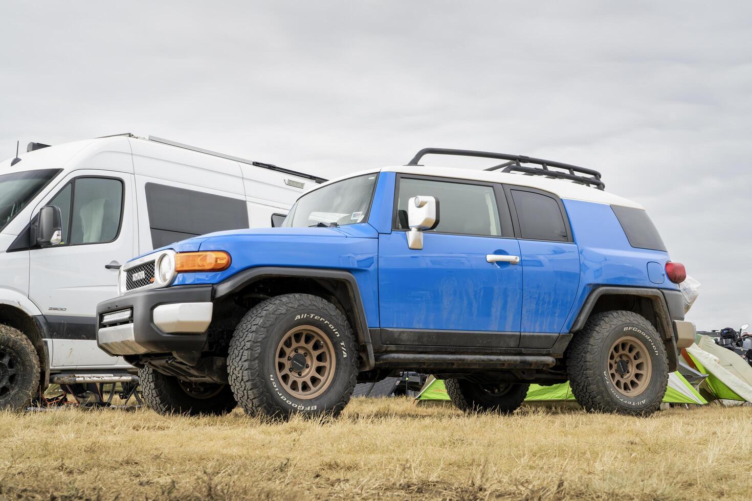 Loveland, CO, USA - August 26, 2023, Toyota FJ Cruiser 4wd SUV with roof racks at a busy campground. photo