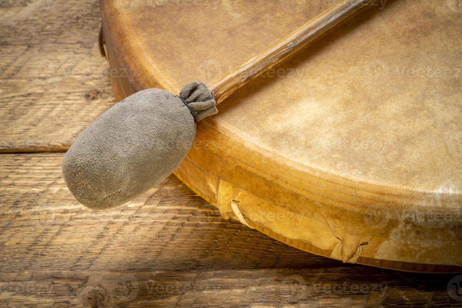 handmade, native American style, shaman frame drum covered by goat skin with a beater or a rustic wood photo