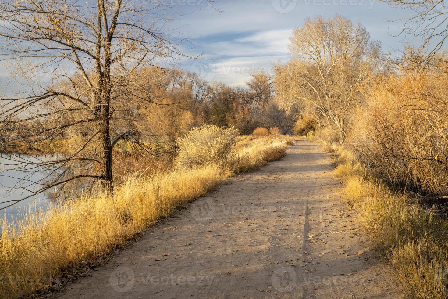 gravel biking and hiking trail in one of natural areas in Fort Collins, Colorado, late fall scenery at sunset photo