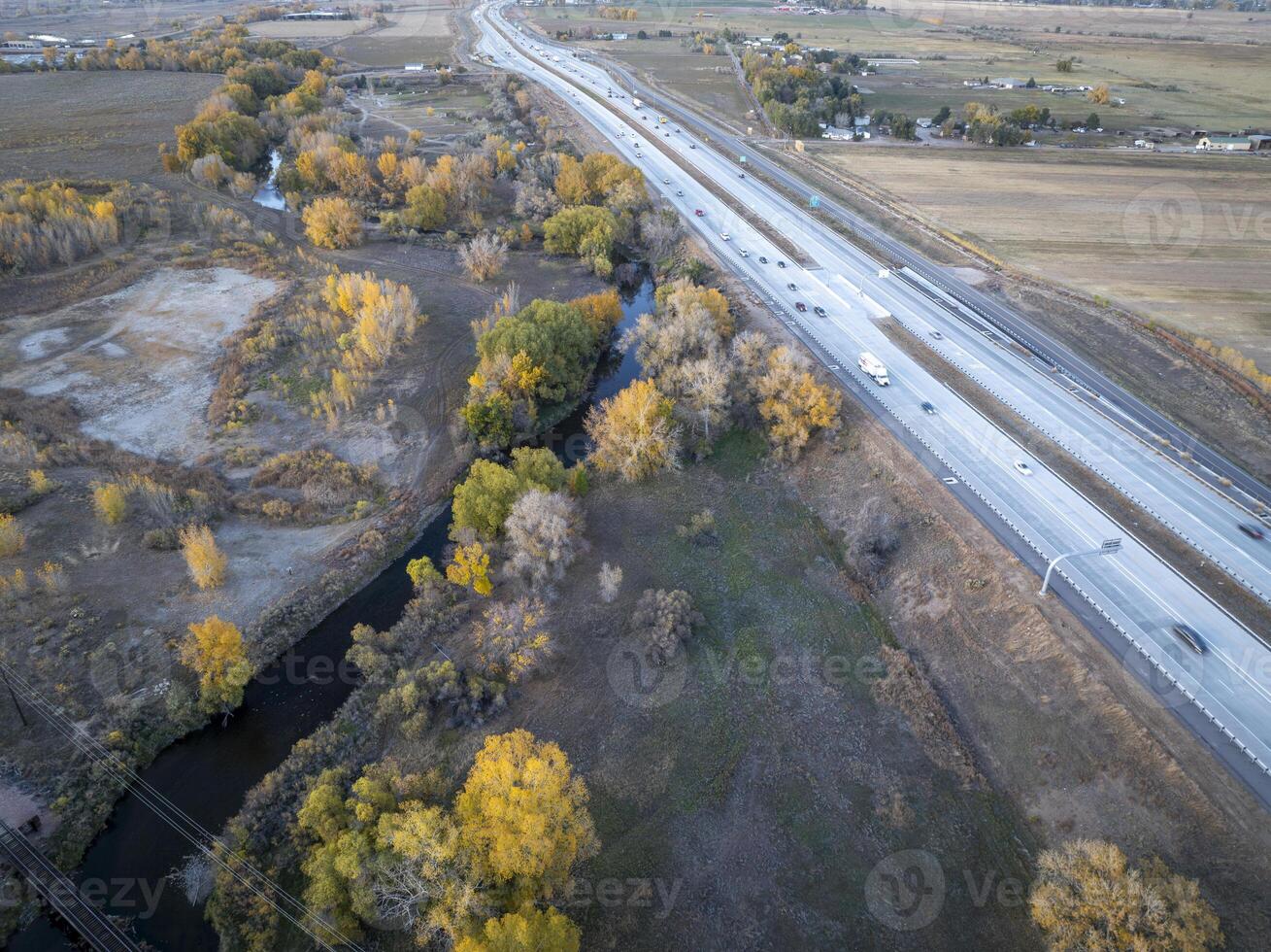 aerial view of Colorado landscape near Fort Collins with evening traffic on I-25 interstate highway and Poudre River photo