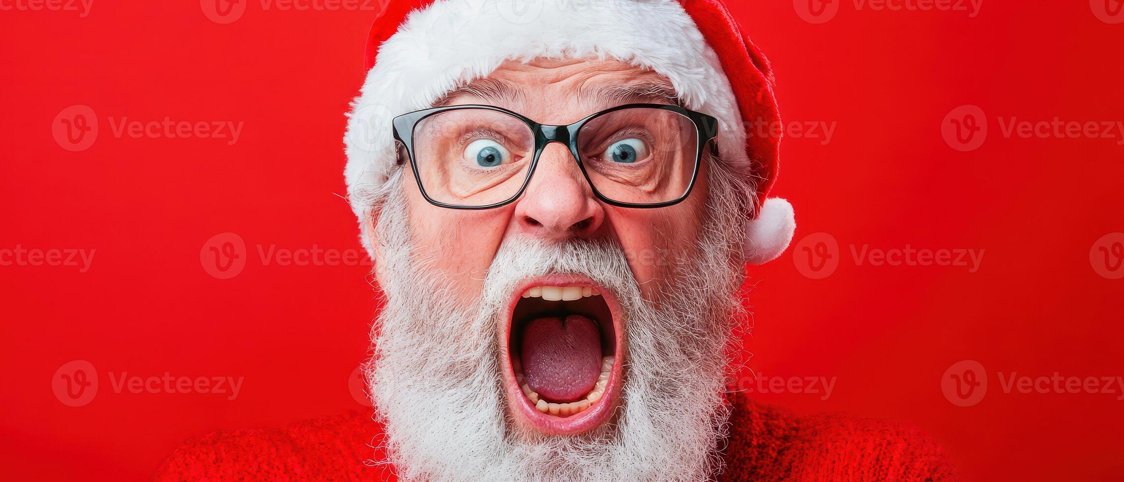 A man in glasses and a red sweater with a santa hat photo